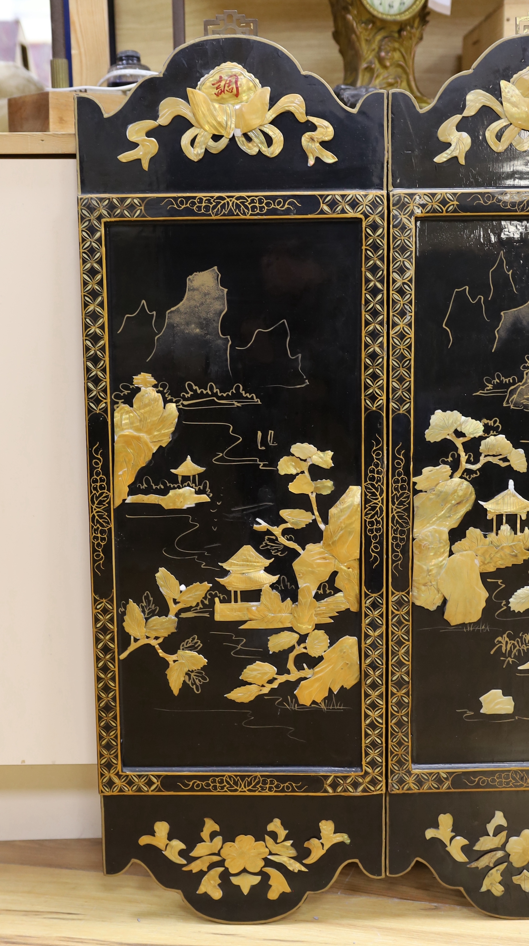 Three Chinese black lacquered, mother of pearl inset and gilt decorated panels, 94cm high